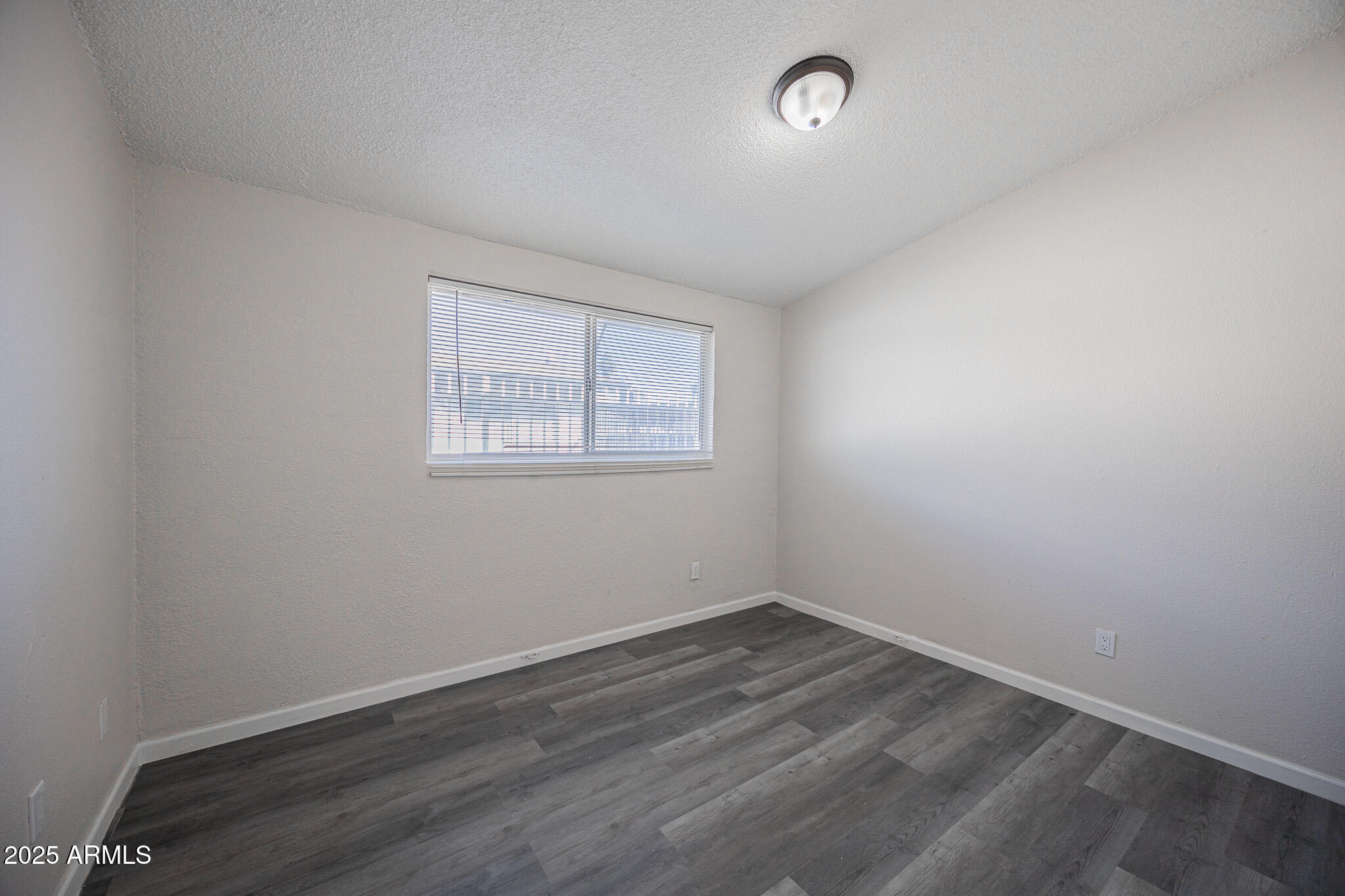 2123 West Devonshire Avenue, Unit 14 Phoenix, AZ 85015 - Photo 10 of 13 an empty room with a window