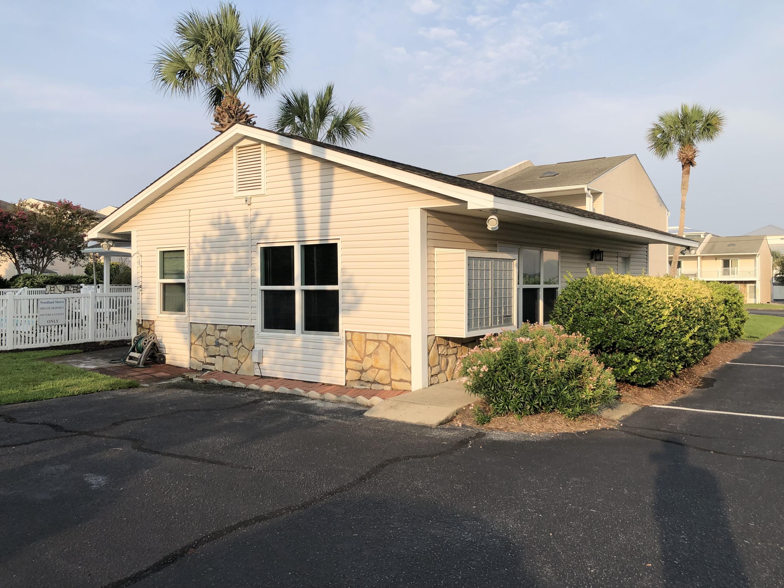 241 Ellis Road, Unit 47 Miramar Beach, FL 32550 - Photo 52 of 61 a front view of a house with a yard and garage