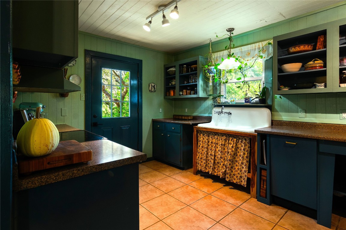 435 Spangenberg Road Blanco, TX 78606 - Photo 13 of 40 a kitchen with stainless steel appliances granite countertop a sink counter space cabinets and a window