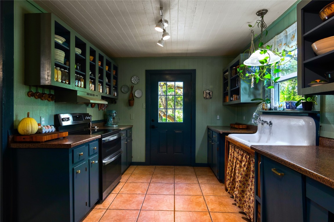 435 Spangenberg Road Blanco, TX 78606 - Photo 15 of 40 a kitchen with stainless steel appliances granite countertop a sink stove and refrigerator