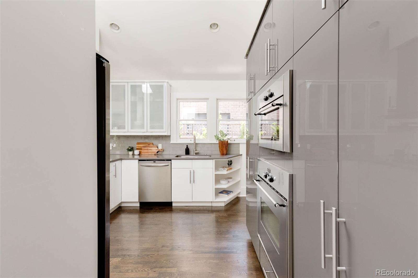 725 Monroe Street Denver, CO 80206 - Photo 13 of 33 a kitchen with cabinets stainless steel appliances and a window