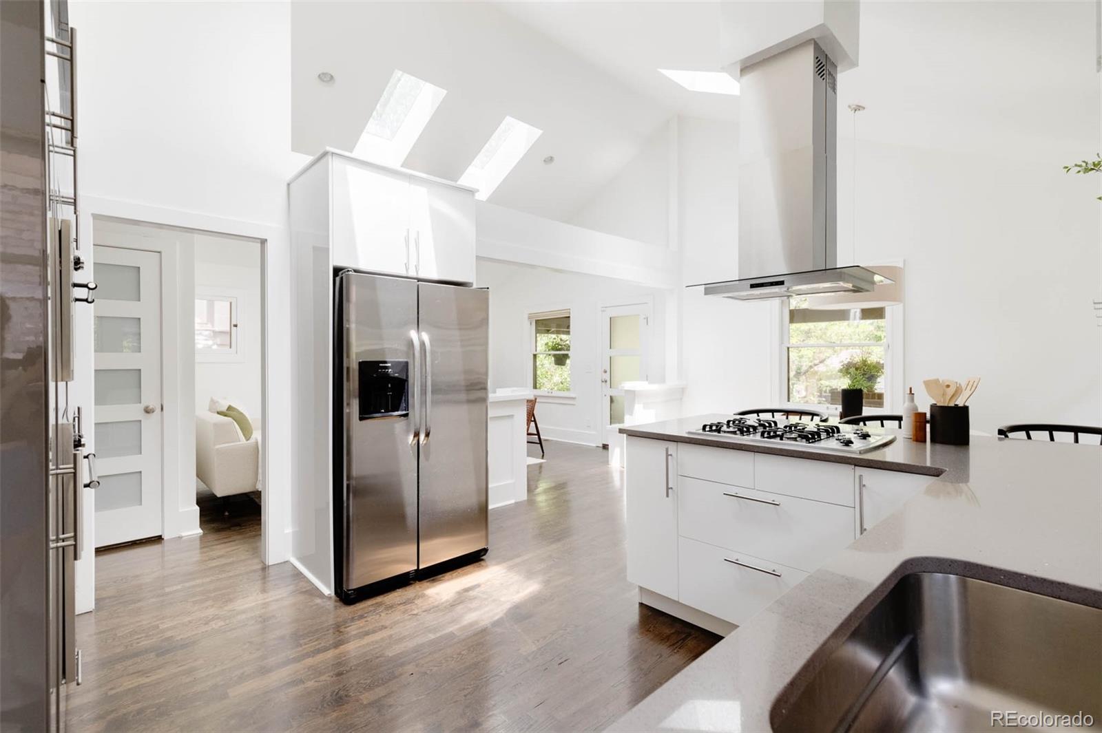 725 Monroe Street Denver, CO 80206 - Photo 14 of 33 a kitchen with stainless steel appliances granite countertop a refrigerator a stove and a sink