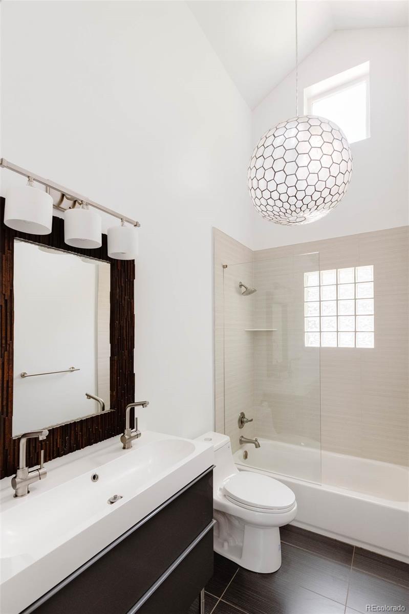 725 Monroe Street Denver, CO 80206 - Photo 18 of 33 a bathroom with a double vanity sink mirror and bathtub