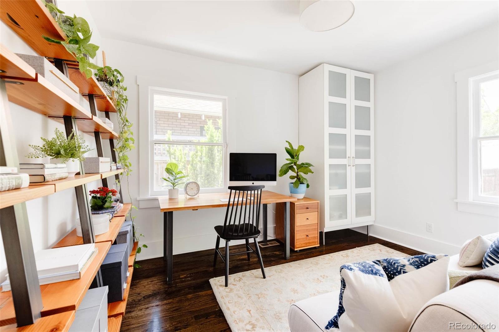 725 Monroe Street Denver, CO 80206 - Photo 19 of 33 a living room with furniture and a flat screen tv