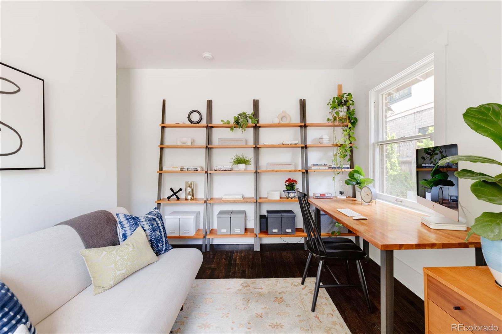 725 Monroe Street Denver, CO 80206 - Photo 20 of 33 a living room with furniture a rug and a table