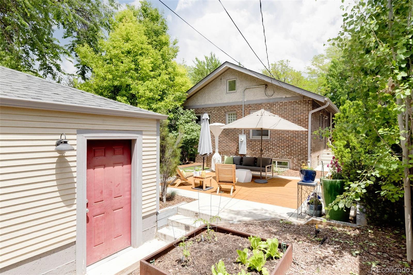 725 Monroe Street Denver, CO 80206 - Photo 21 of 33 a backyard of a house with outdoor seating