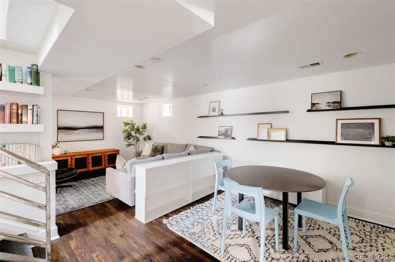725 Monroe Street Denver, CO 80206 - Photo 22 of 33 a living room with furniture and paintings on the wall