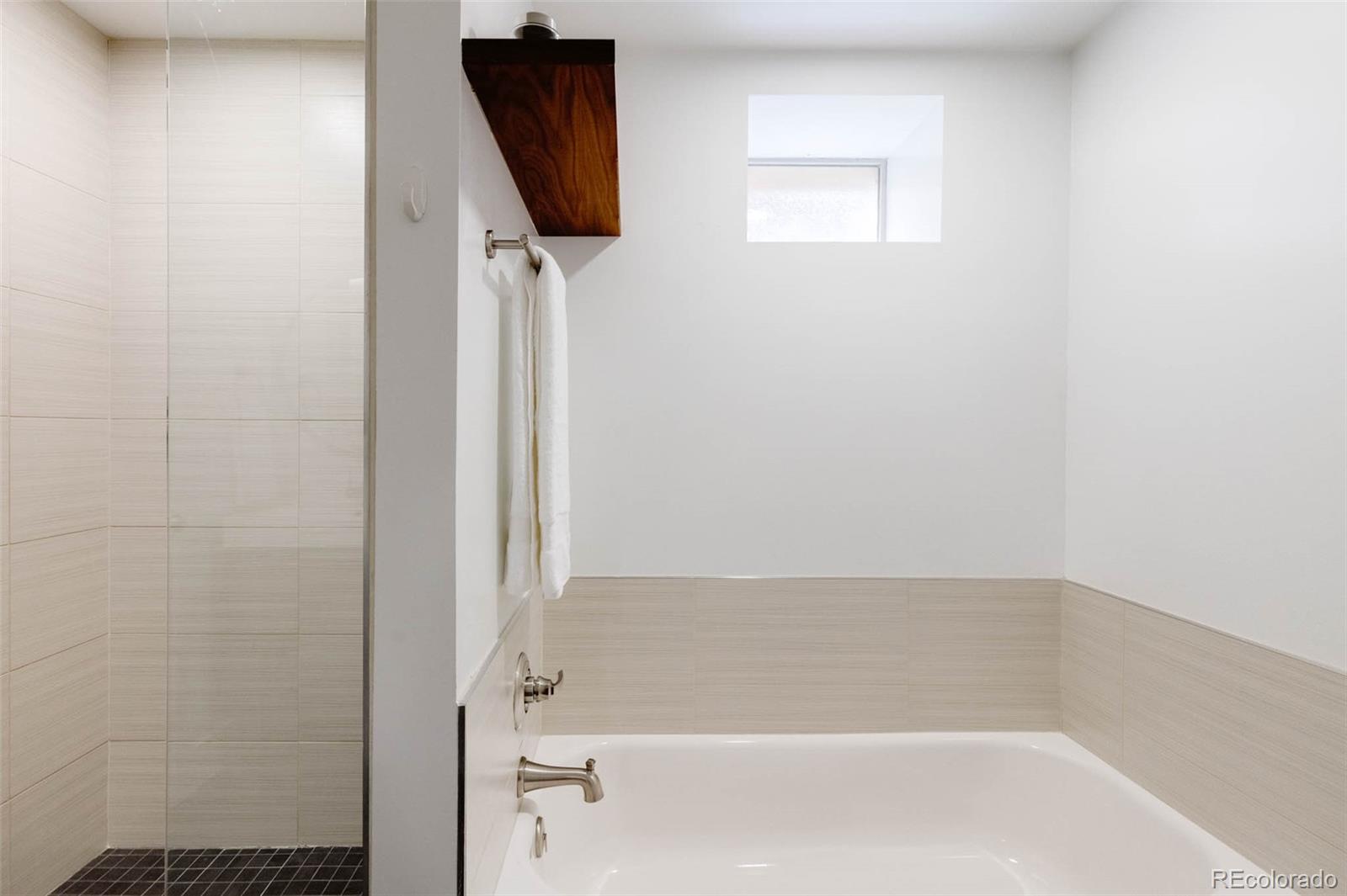 725 Monroe Street Denver, CO 80206 - Photo 27 of 33 a bathroom with a bathtub