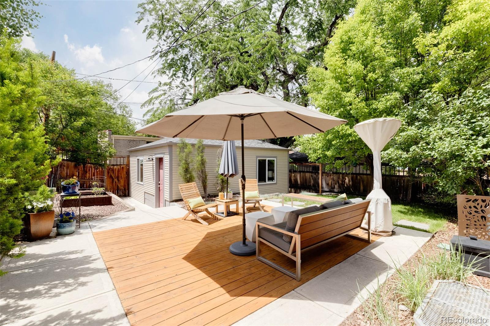 725 Monroe Street Denver, CO 80206 - Photo 29 of 33 a view of a patio with chairs and a table and chairs under an umbrella