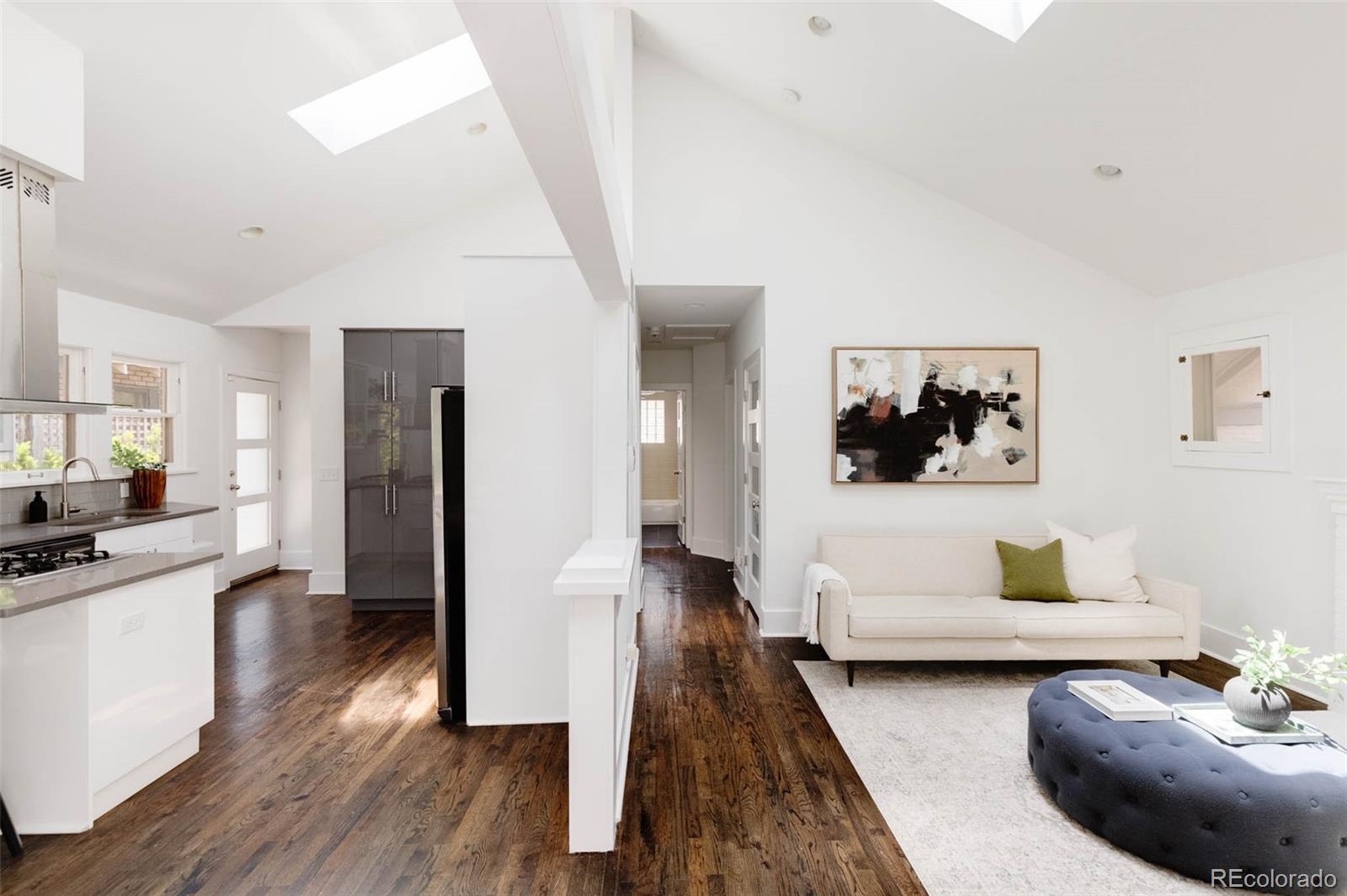 725 Monroe Street Denver, CO 80206 - Photo 3 of 33 a living room with furniture and a wooden floor