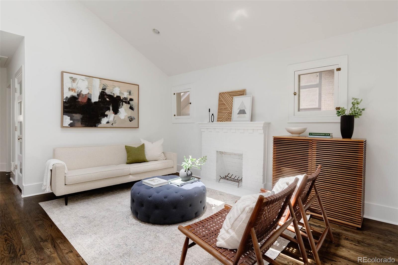 725 Monroe Street Denver, CO 80206 - Photo 4 of 33 a living room with furniture and a painting on the wall