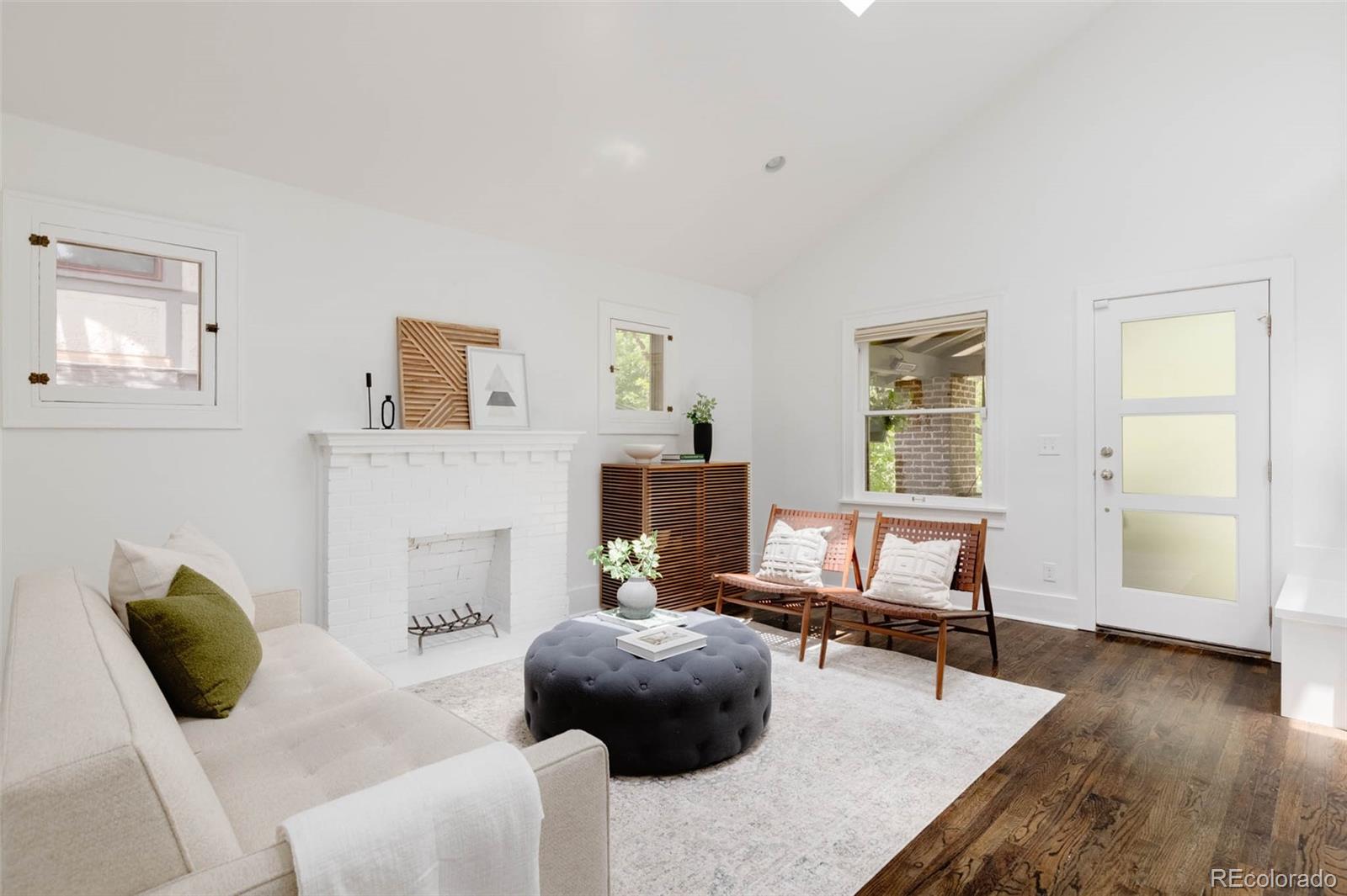 725 Monroe Street Denver, CO 80206 - Photo 7 of 33 a bedroom with a bed and wooden floor