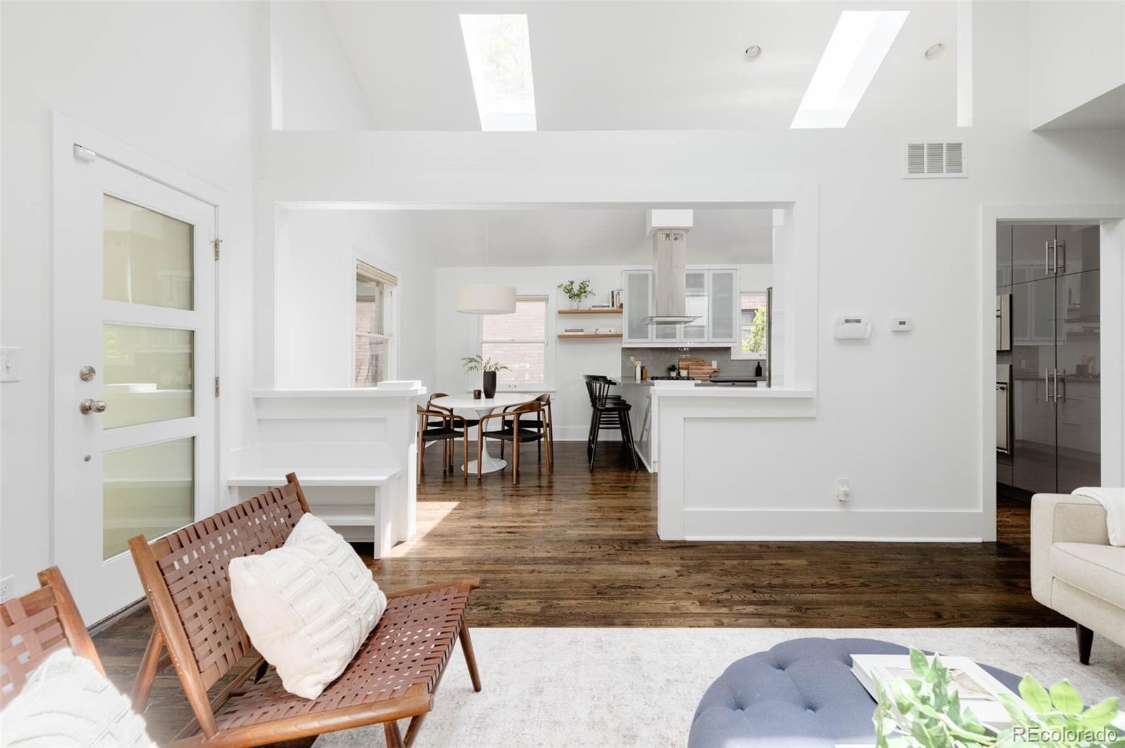 725 Monroe Street Denver, CO 80206 - Photo 8 of 33 a living room with lots of furniture and kitchen view