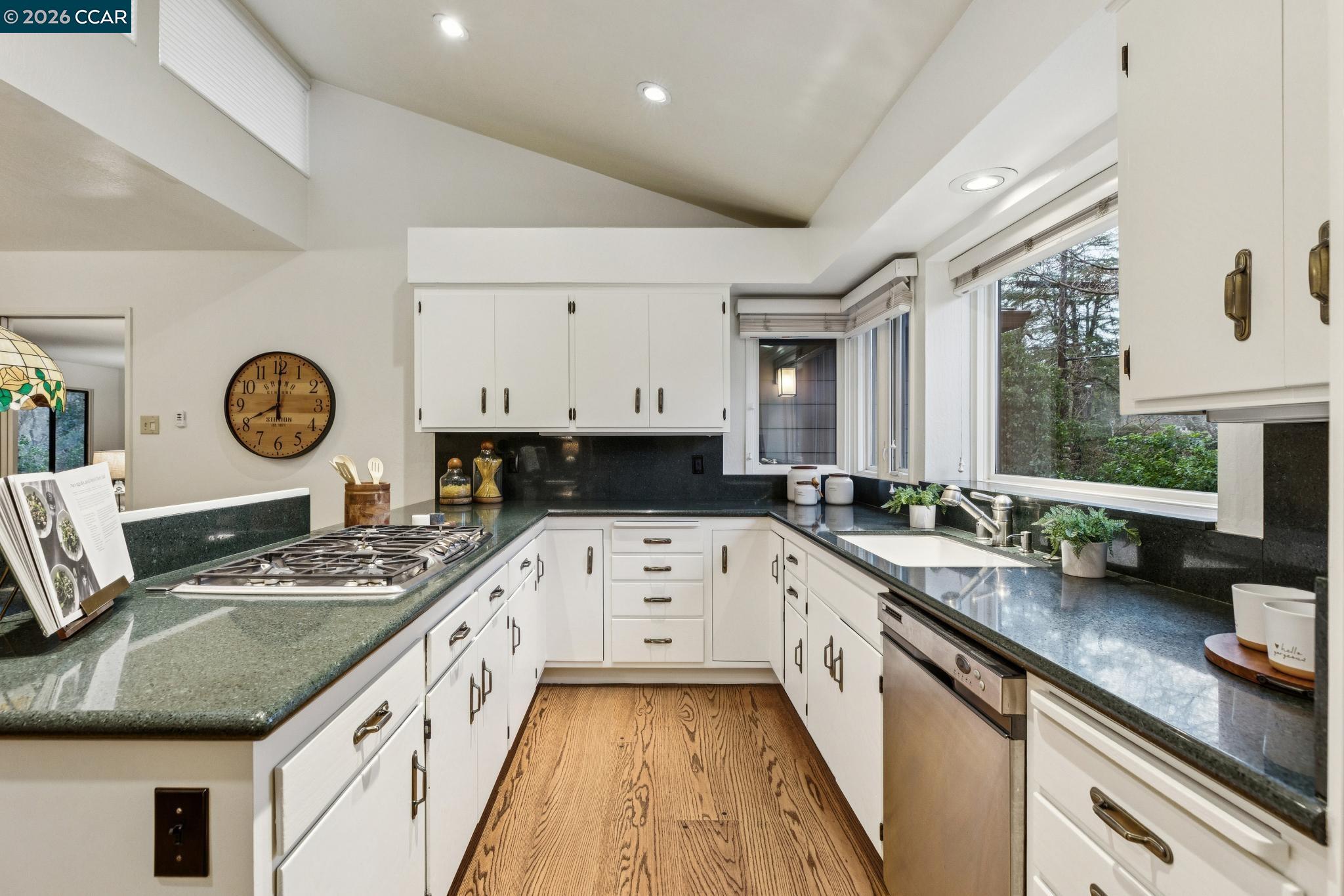 411 La Vista Road Walnut Creek, CA 94598 - Photo 15 of 57 a kitchen with stainless steel appliances granite countertop a sink stove and cabinets