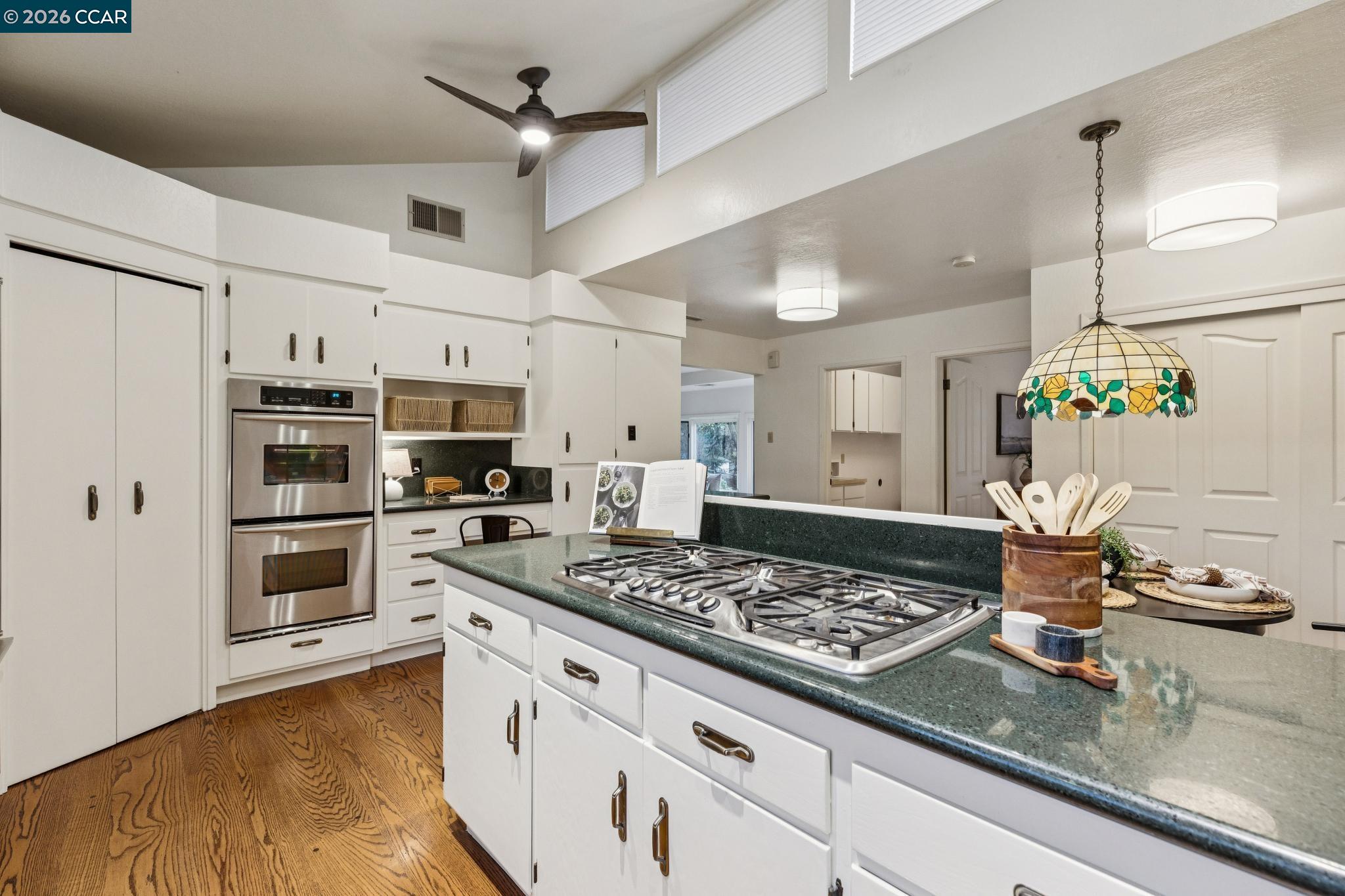 411 La Vista Road Walnut Creek, CA 94598 - Photo 17 of 57 a kitchen with a stove and a wooden floor