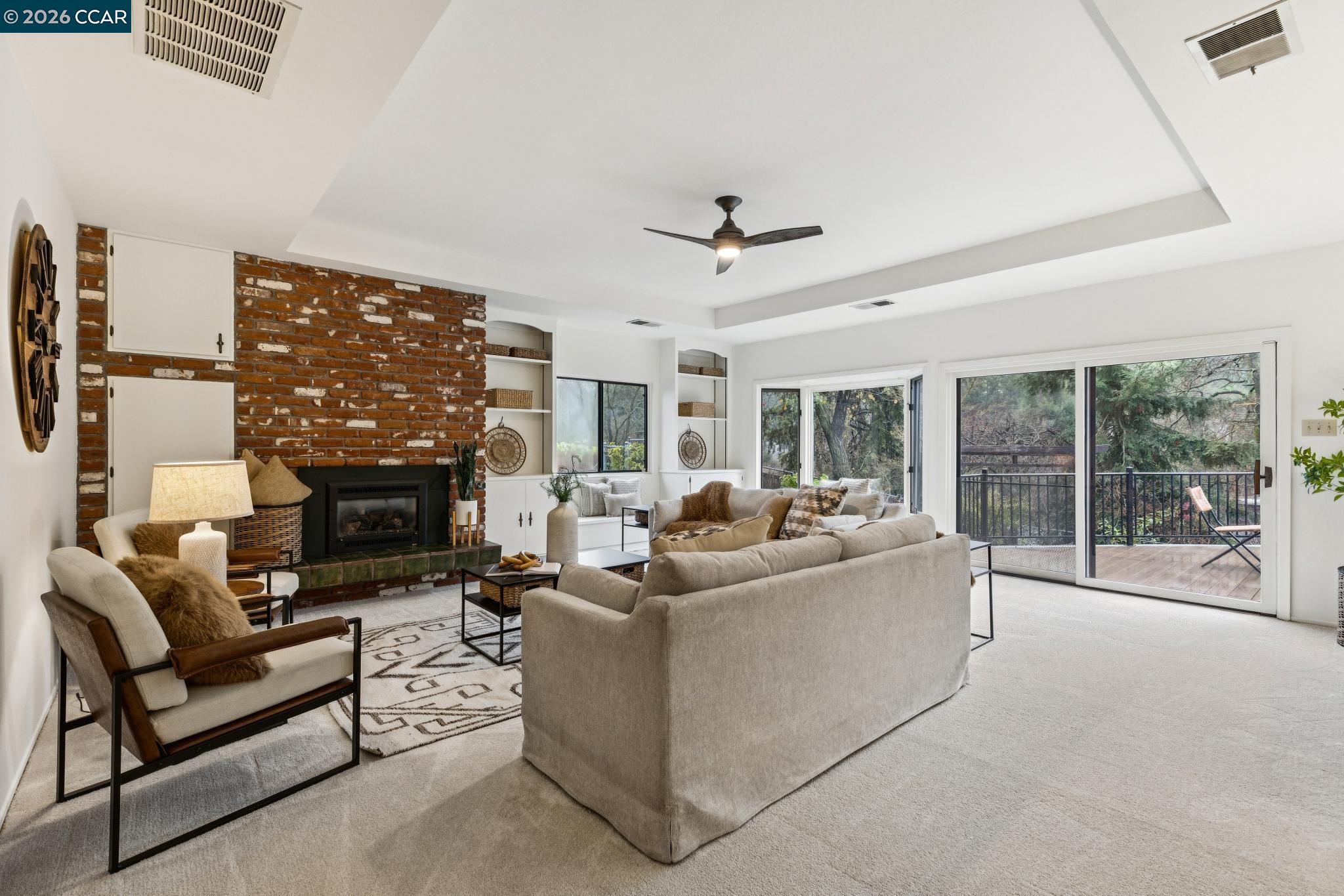 411 La Vista Road Walnut Creek, CA 94598 - Photo 19 of 57 a living room with furniture a fireplace and a floor to ceiling window