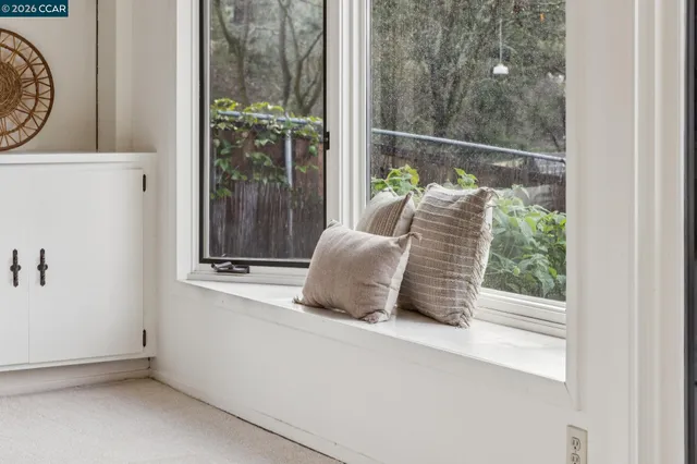 a bedroom with a bed potted plant with the window