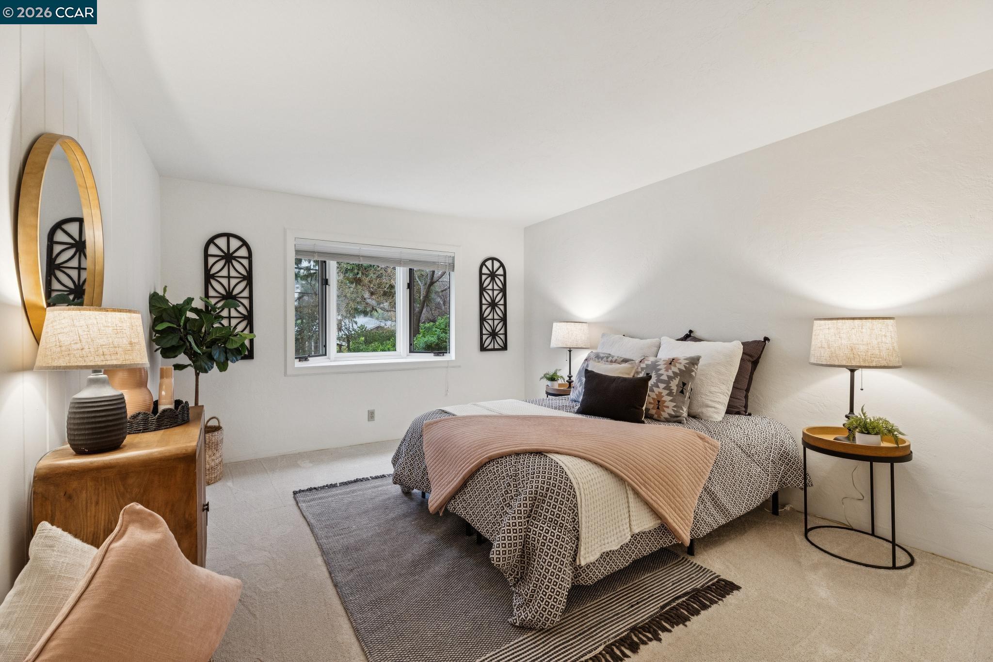 411 La Vista Road Walnut Creek, CA 94598 - Photo 27 of 57 a bedroom with a bed a couch and a potted plant