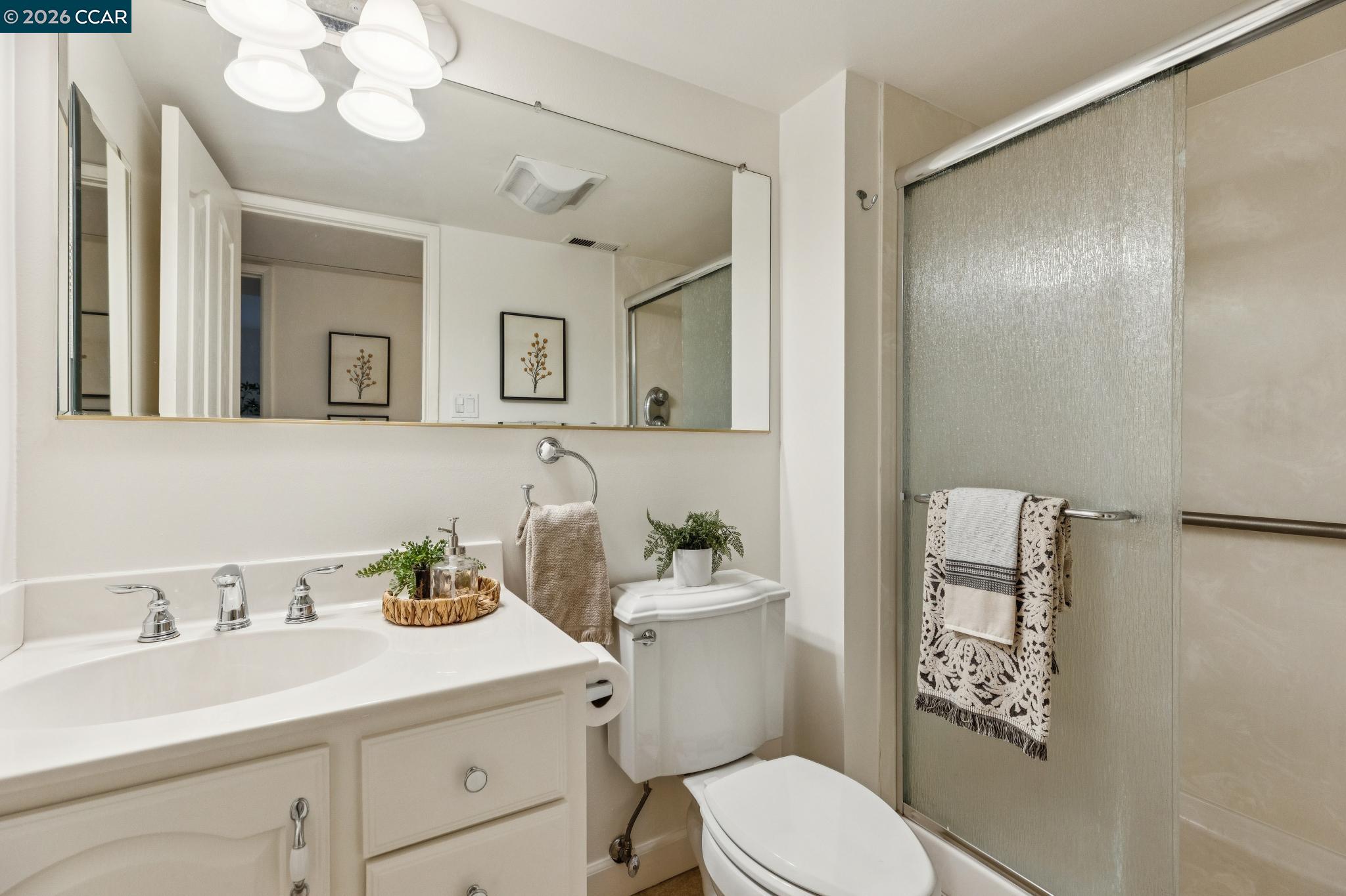 411 La Vista Road Walnut Creek, CA 94598 - Photo 31 of 57 a bathroom with a sink a toilet and a mirror