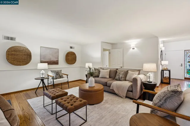a dining room with furniture and wooden floor