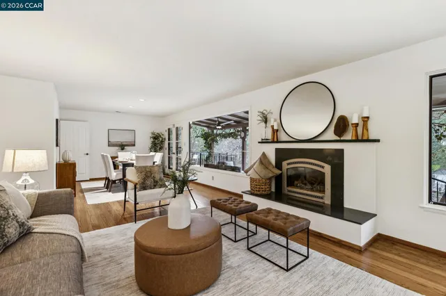 a kitchen with stainless steel appliances kitchen island granite countertop a dining table chairs and view living room