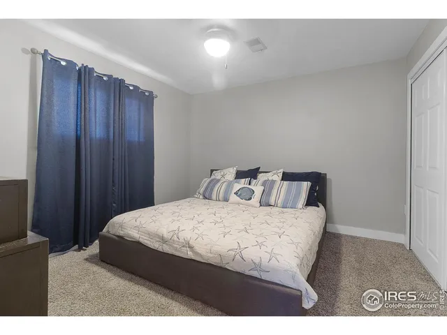 a bedroom with a bed and a night stand