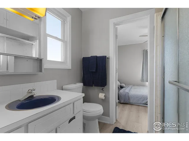 a bathroom with a sink toilet a mirror and vanity