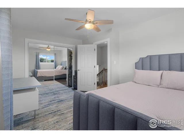 a living room with a bed furniture and a kitchen view