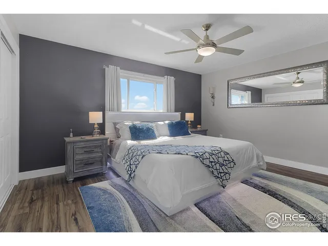 a bedroom with a large bed and a ceiling fan