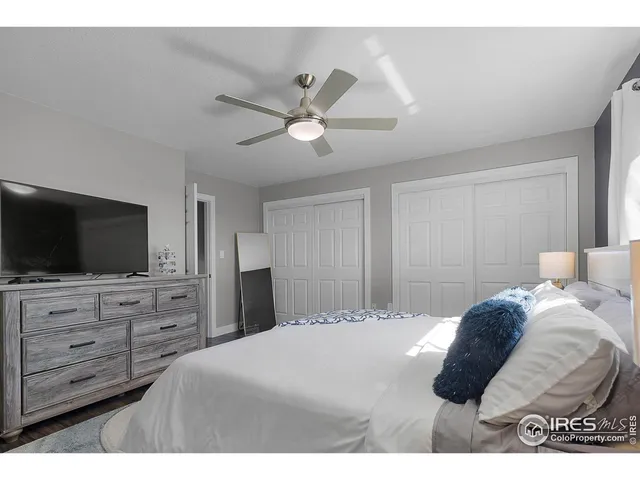 a bedroom with a large bed and a flat screen tv