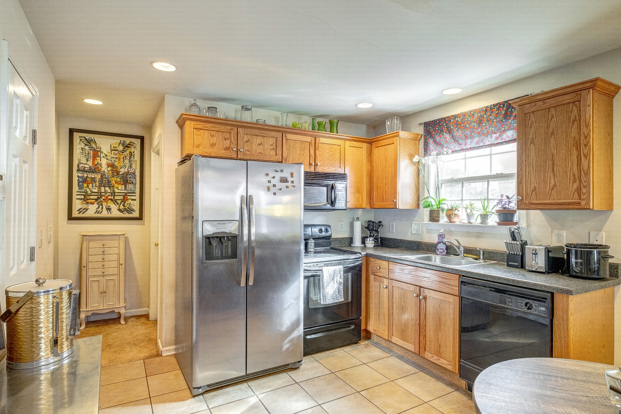 725 Neelys Bend Road Madison, TN 37115 - Photo 6 of 13 a kitchen with stainless steel appliances granite countertop a stove a sink dishwasher a refrigerator and cabinets with wooden floor