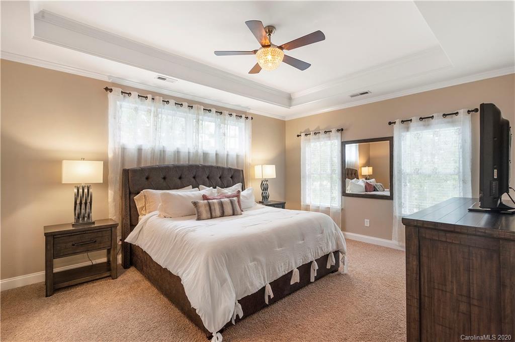 2011 Fallondale Road Waxhaw, NC 28173 - Photo 22 of 39 a bedroom with a bed and a flat screen tv