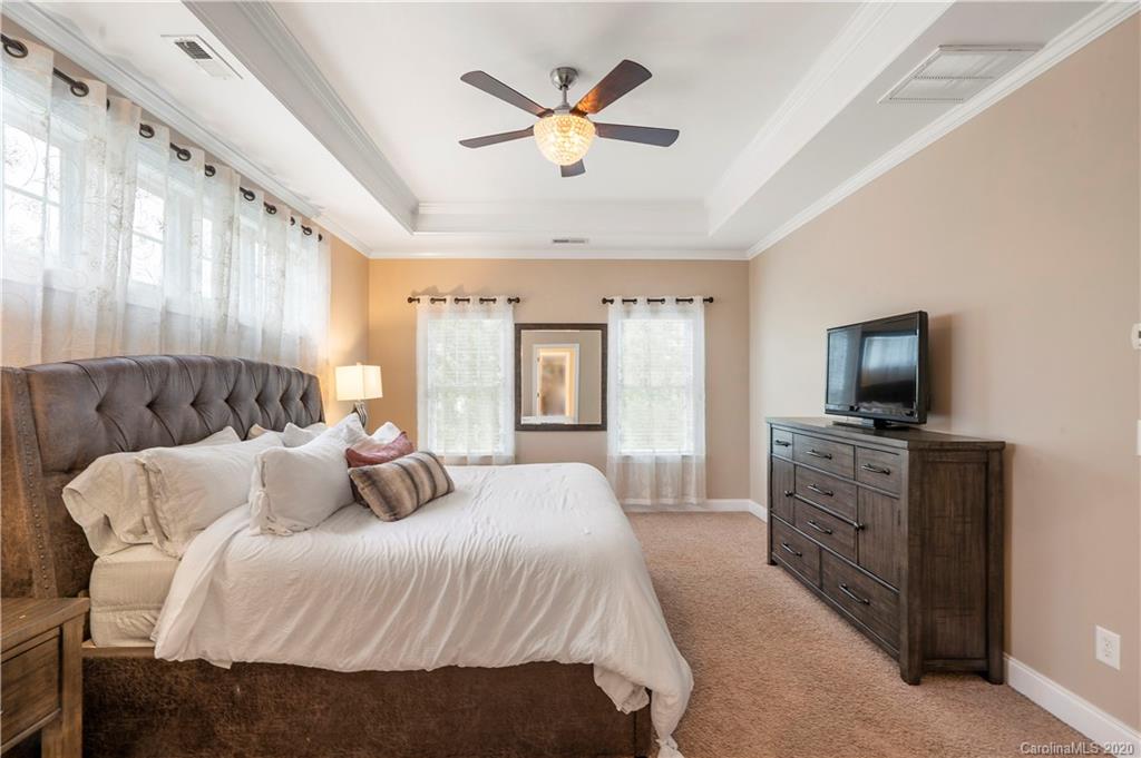 2011 Fallondale Road Waxhaw, NC 28173 - Photo 23 of 39 a bedroom with a large bed and a tv
