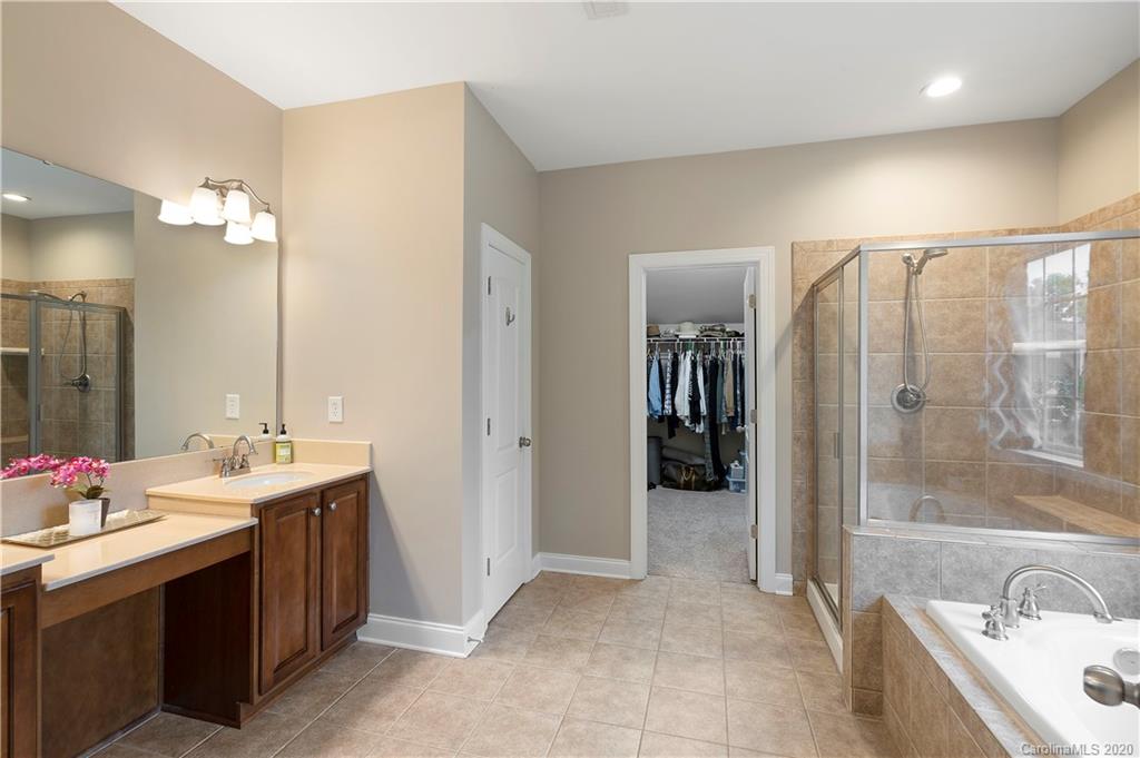 2011 Fallondale Road Waxhaw, NC 28173 - Photo 25 of 39 a spacious bathroom with a bathtub sink and mirror