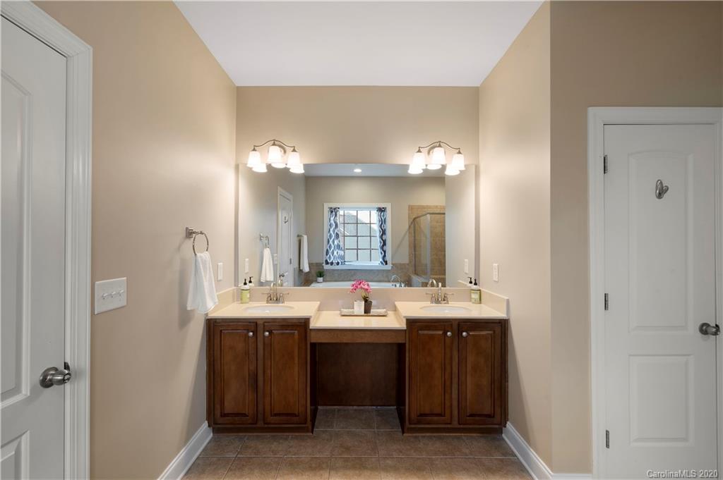 2011 Fallondale Road Waxhaw, NC 28173 - Photo 26 of 39 a bathroom with a double vanity sink and a mirror
