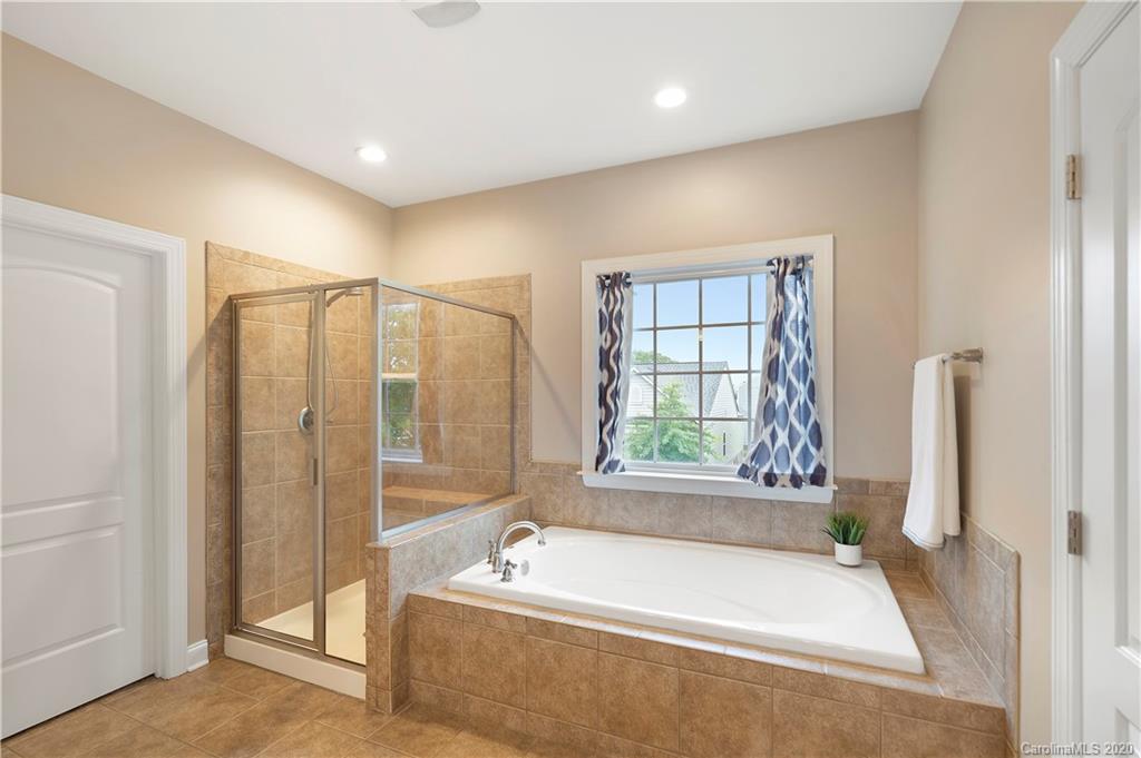 2011 Fallondale Road Waxhaw, NC 28173 - Photo 27 of 39 a spacious bathroom with a tub and a shower