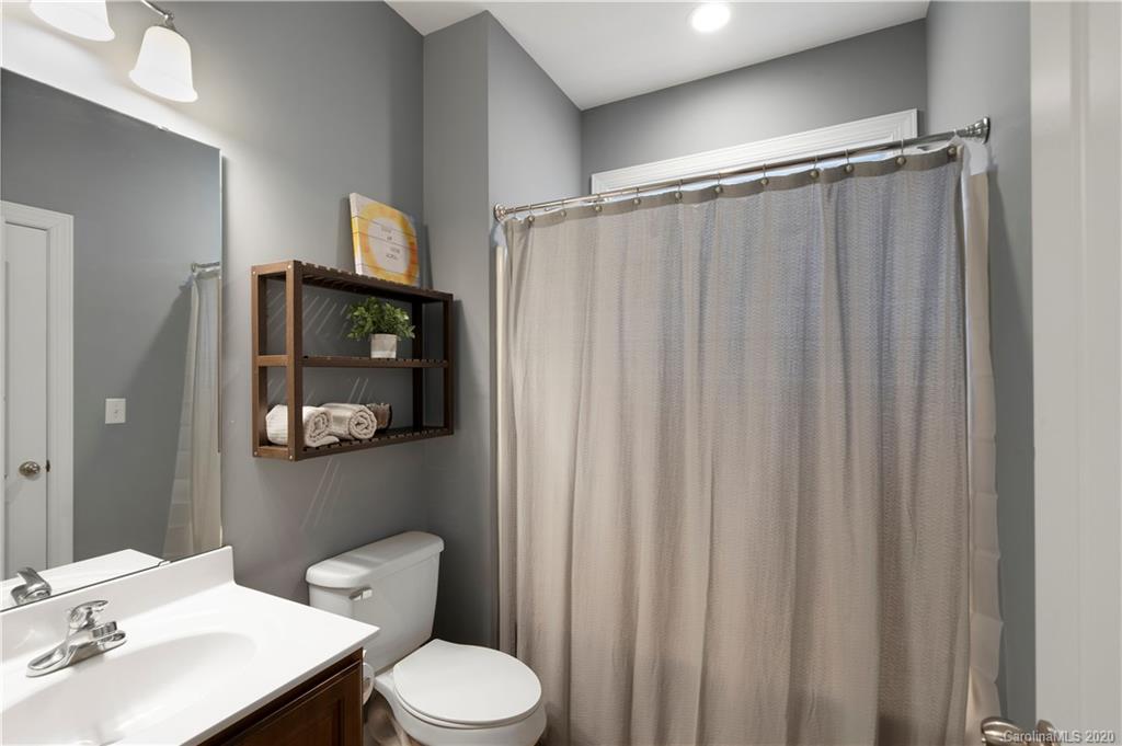 2011 Fallondale Road Waxhaw, NC 28173 - Photo 29 of 39 a bathroom with a toilet a sink and curtain