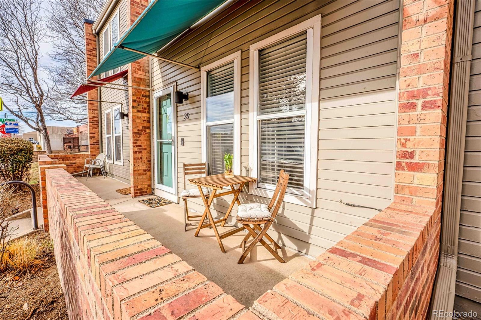 a view of a patio with a table and chairs
