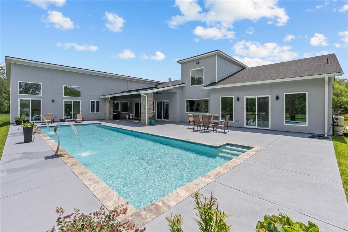 7627 Scott Avenue Manvel, TX 77578 - Photo 3 of 50 The massive 50’ x 20’ swimming pool serves as the centerpiece of this property.