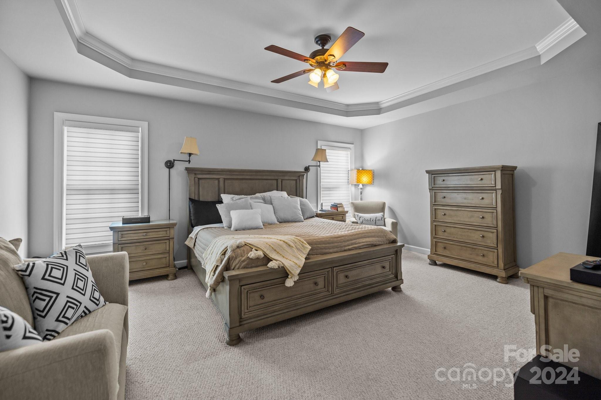 309 Chancelot Lane Fort Mill, SC 29708 - Photo 12 of 43 a bedroom with a bed a couch and a chandelier