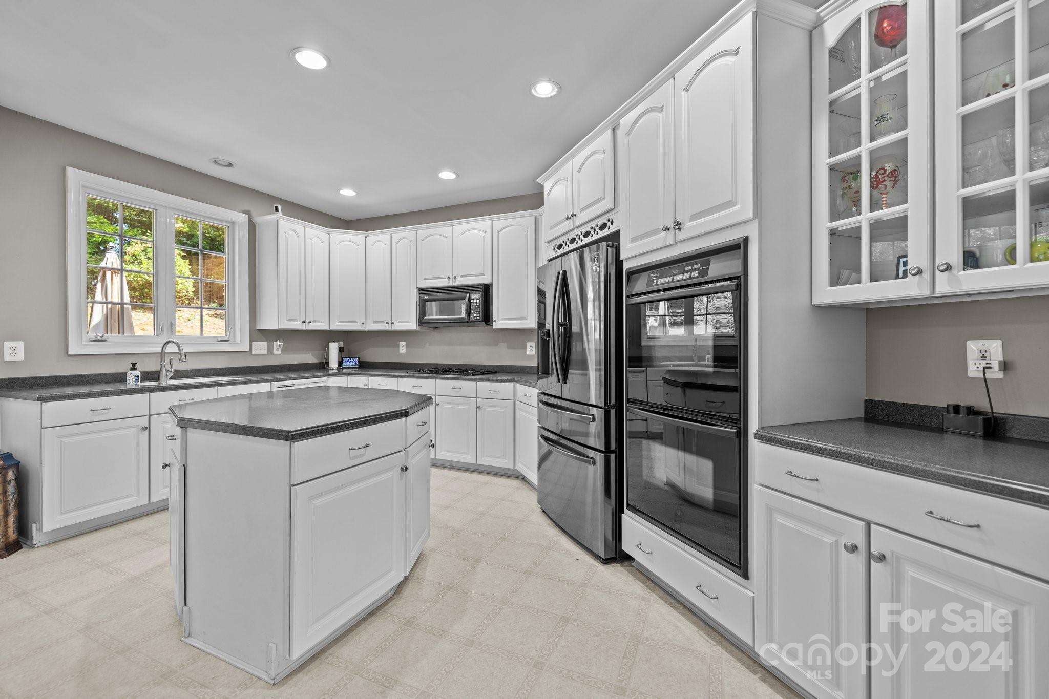 309 Chancelot Lane Fort Mill, SC 29708 - Photo 17 of 43 a kitchen with stainless steel appliances granite countertop a refrigerator sink and cabinets