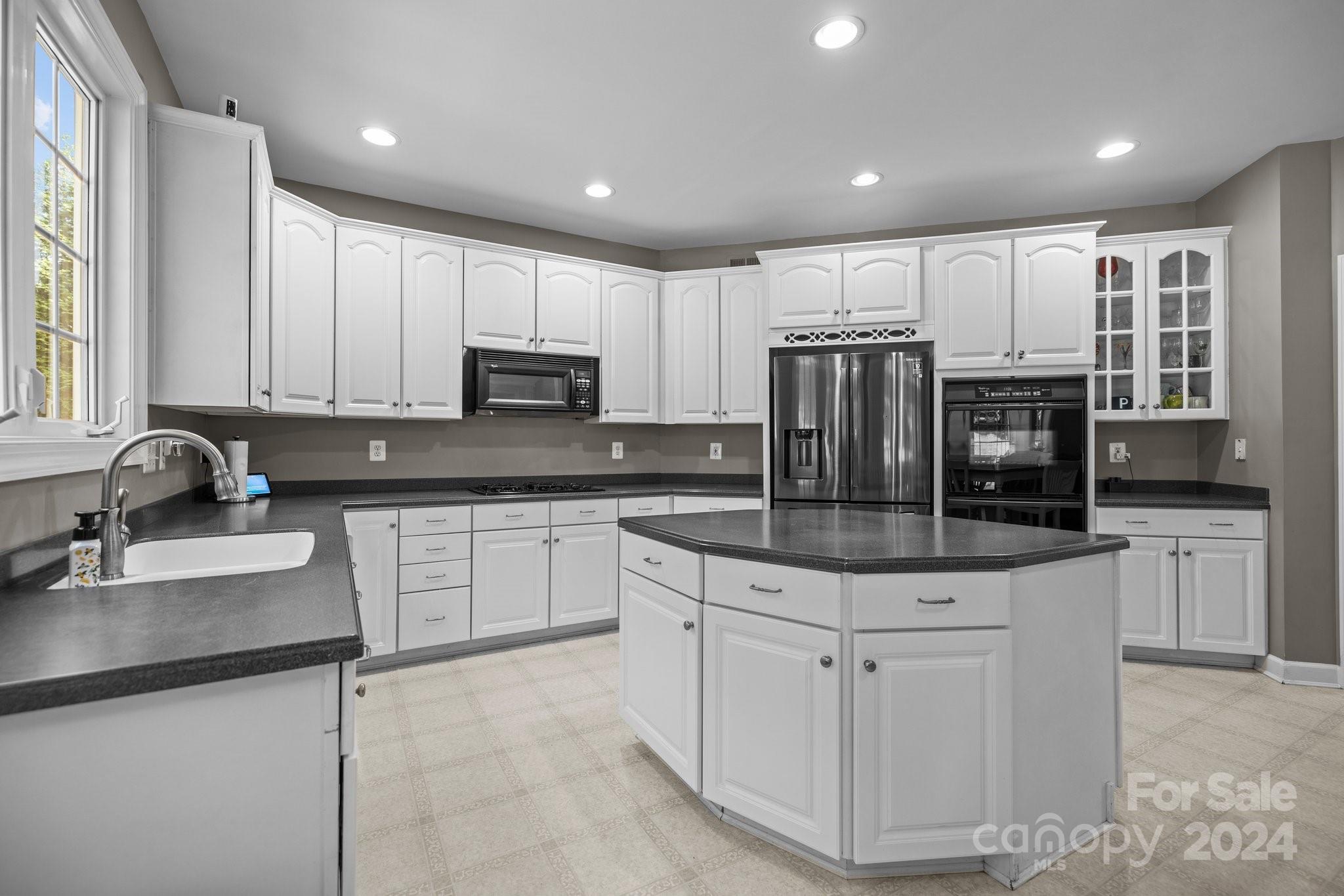 309 Chancelot Lane Fort Mill, SC 29708 - Photo 18 of 43 a kitchen with stainless steel appliances granite countertop a sink stove and refrigerator