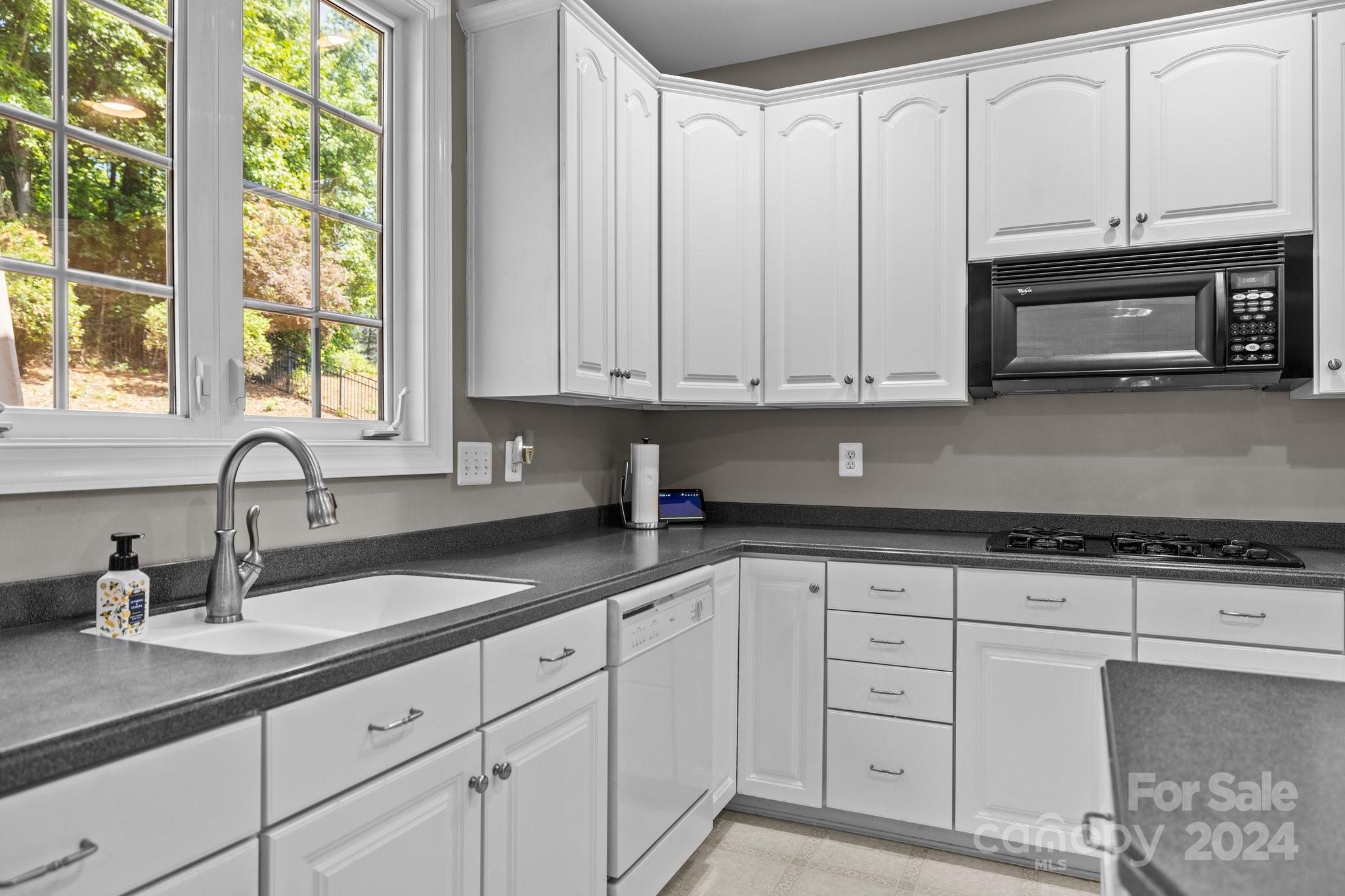 309 Chancelot Lane Fort Mill, SC 29708 - Photo 19 of 43 a kitchen with granite countertop white cabinets and sink