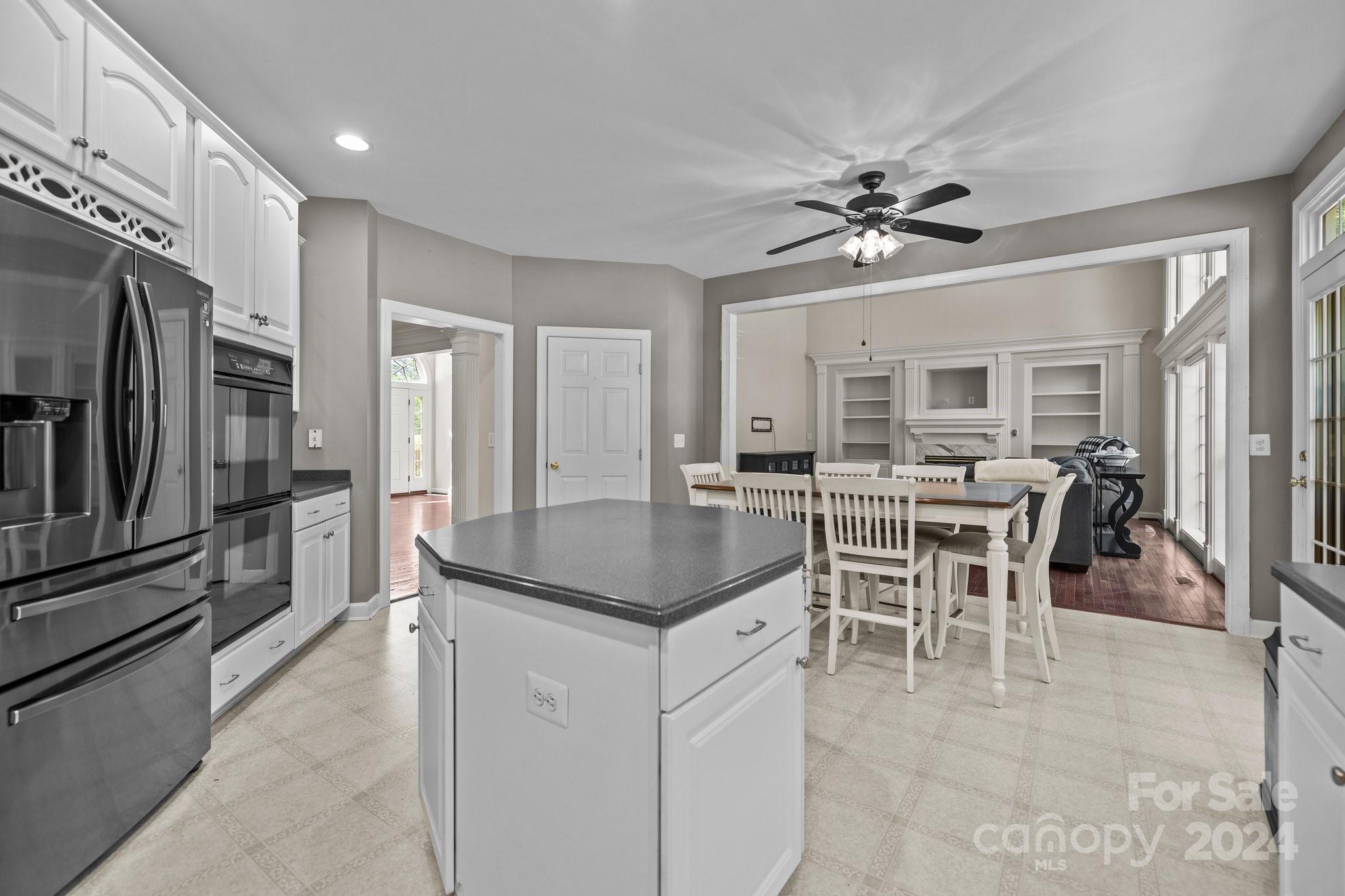 309 Chancelot Lane Fort Mill, SC 29708 - Photo 21 of 43 a kitchen with a table chairs refrigerator and cabinets