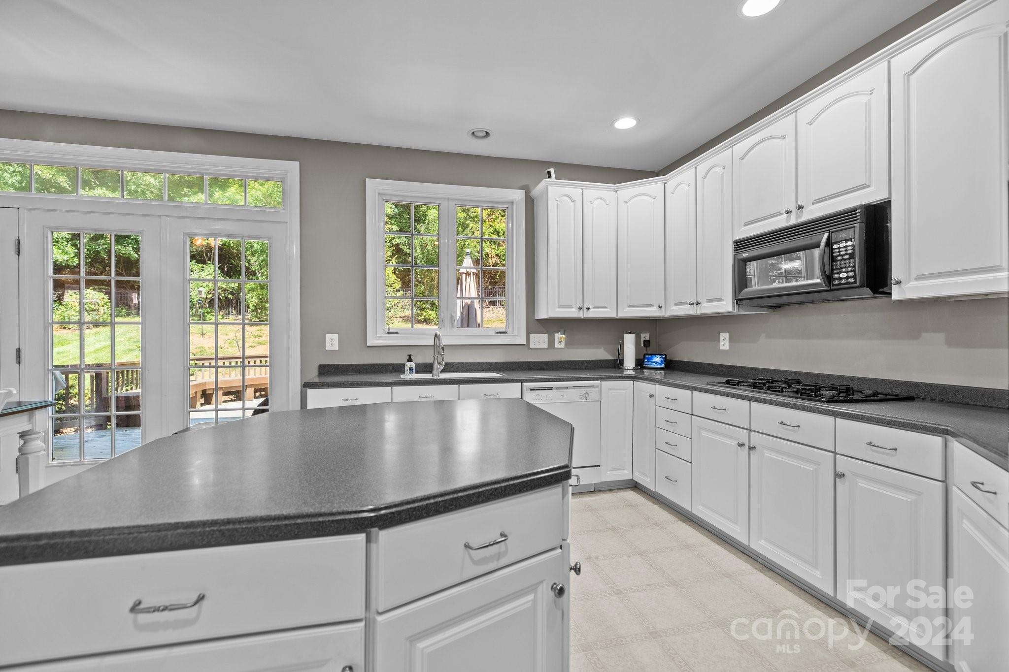 309 Chancelot Lane Fort Mill, SC 29708 - Photo 22 of 43 a modern kitchen with stainless steel appliances granite countertop a stove a sink and a microwave