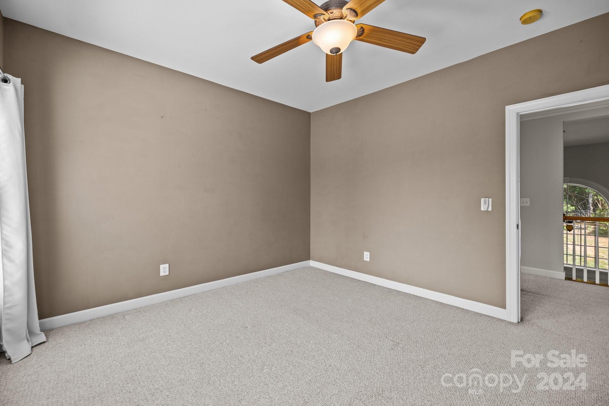 309 Chancelot Lane Fort Mill, SC 29708 - Photo 32 of 43 an empty room with closet and a chandelier fan