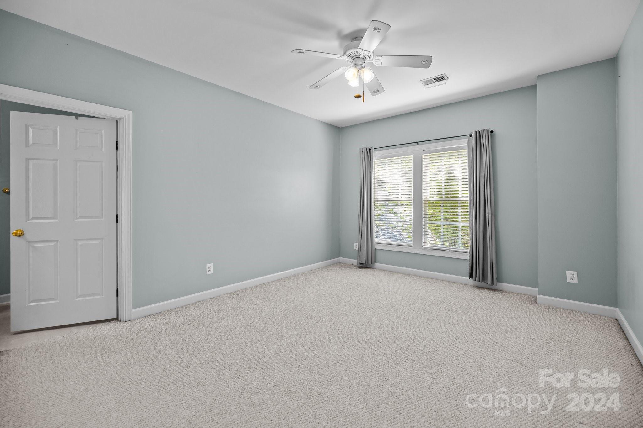 309 Chancelot Lane Fort Mill, SC 29708 - Photo 37 of 43 an empty room with chandelier fan and windows