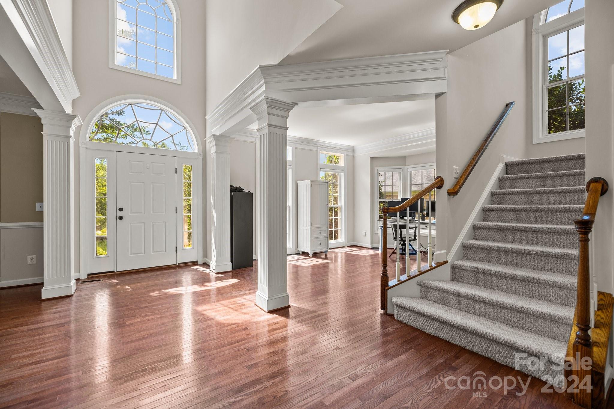 309 Chancelot Lane Fort Mill, SC 29708 - Photo 9 of 43 a view of a hallway with entryway wooden floor and front door