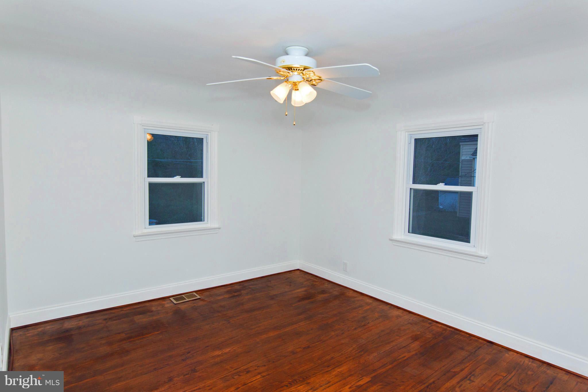 630 Warwick Road Baltimore, MD 21229 - Photo 11 of 23 a view of wooden floor and a chandelier fan in a room