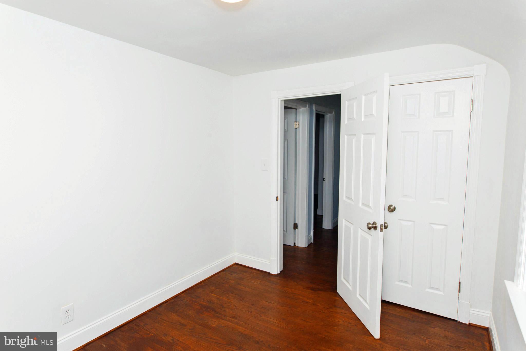 630 Warwick Road Baltimore, MD 21229 - Photo 12 of 23 an empty room with wooden floor and closet